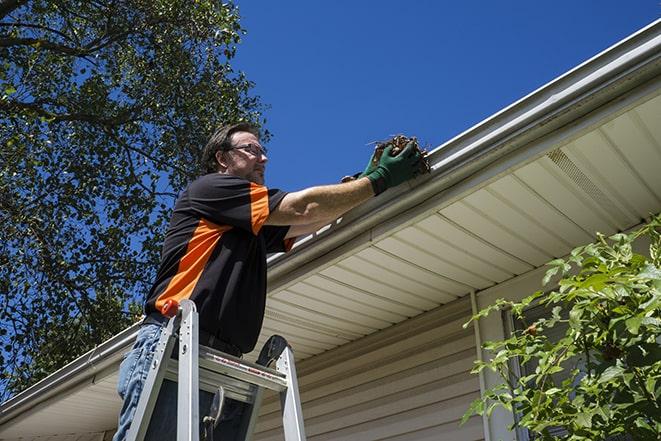 a technician repairing a gutter system in Brownsville IN